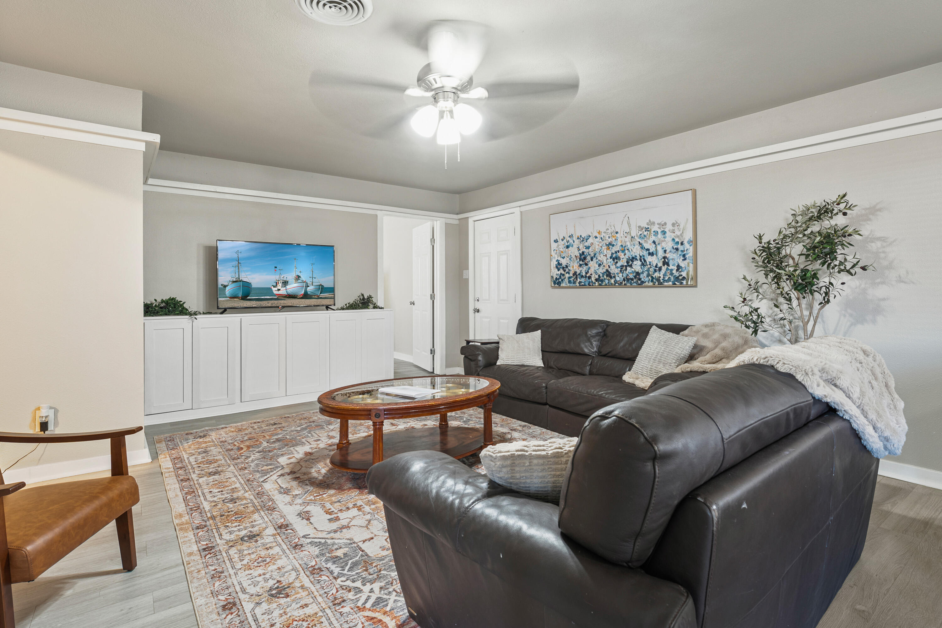 5217 9th Street Lubbock, TX 79416 - Photo 4 of 18 a living room with furniture and a chandelier