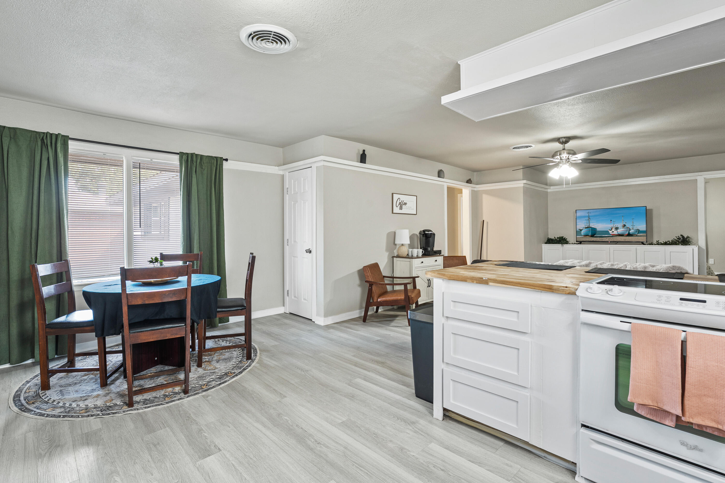 5217 9th Street Lubbock, TX 79416 - Photo 6 of 18 a kitchen with a table chairs stove and wooden floor