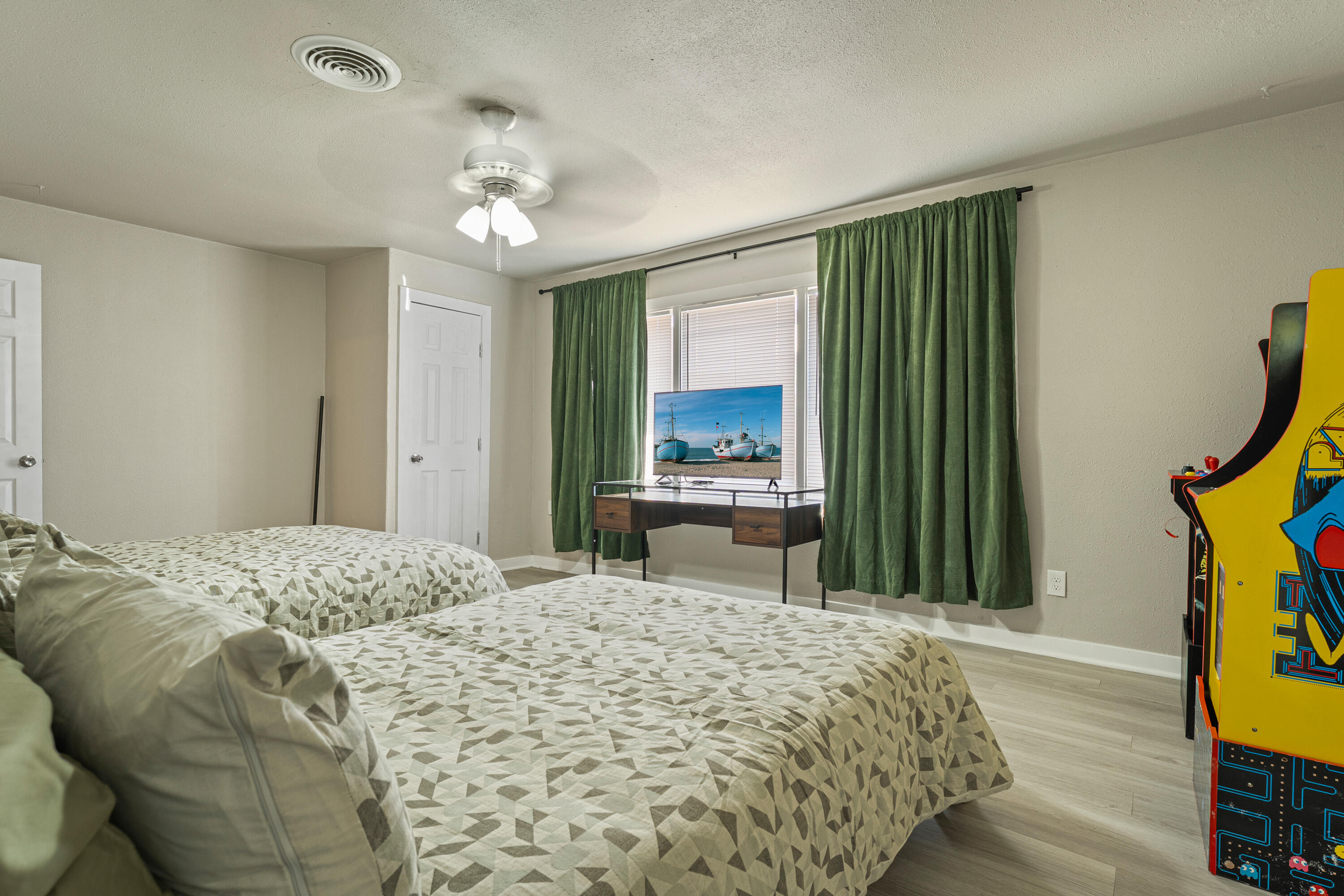 5217 9th Street Lubbock, TX 79416 - Photo 7 of 18 a bedroom with a bed and a large mirror on the dresser