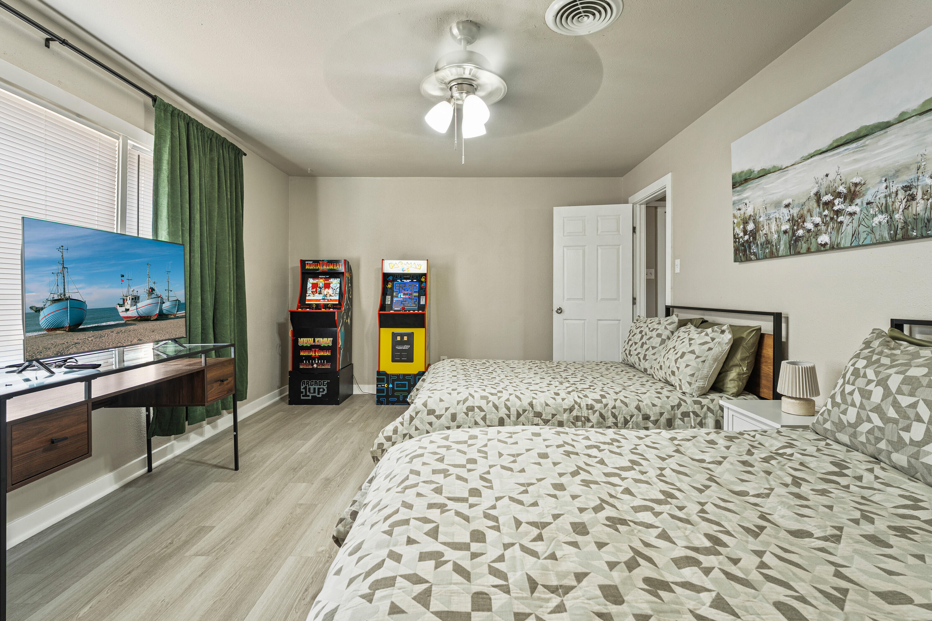 5217 9th Street Lubbock, TX 79416 - Photo 8 of 18 a bedroom with a bed and a flat screen tv