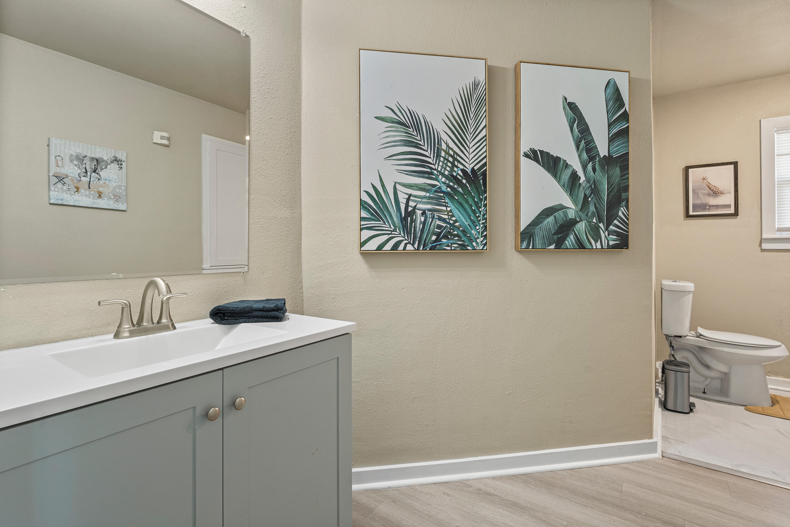 5217 9th Street Lubbock, TX 79416 - Photo 9 of 18 a bathroom with a sink a mirror and a toilet