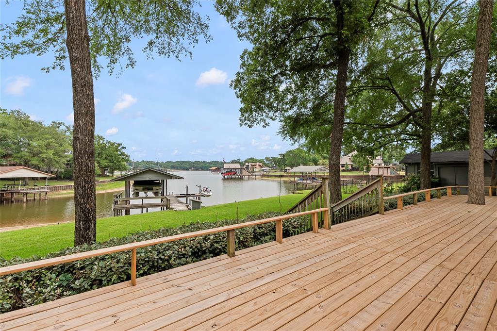 111 Deer Island Road Mabank, TX 75156 - Photo 3 of 26 Just off the sunroom, step onto the back porch overlooking the peaceful cove. Perfect setting to relax and enjoy tranquil waterfront views.