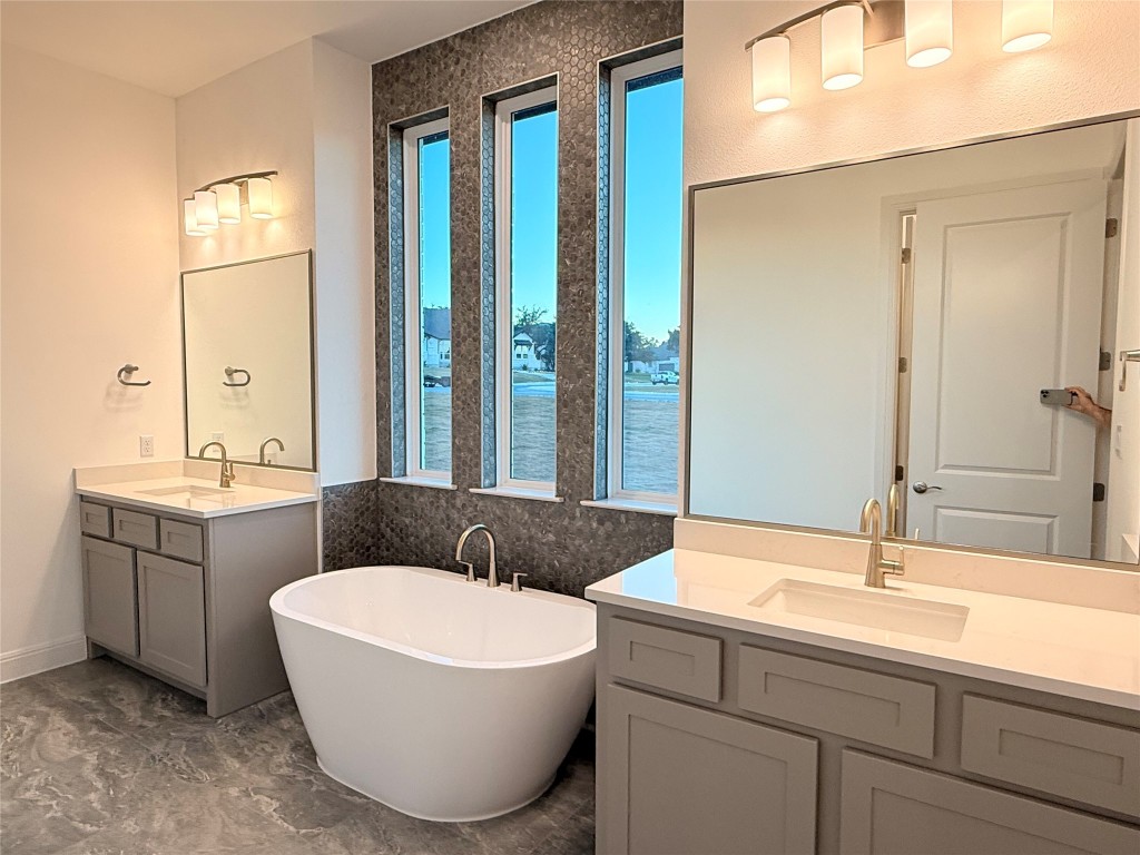 204 Rusty Colt Liberty Hill, TX 78642 - Photo 11 of 20 a bathroom with a granite countertop sink and a mirror
