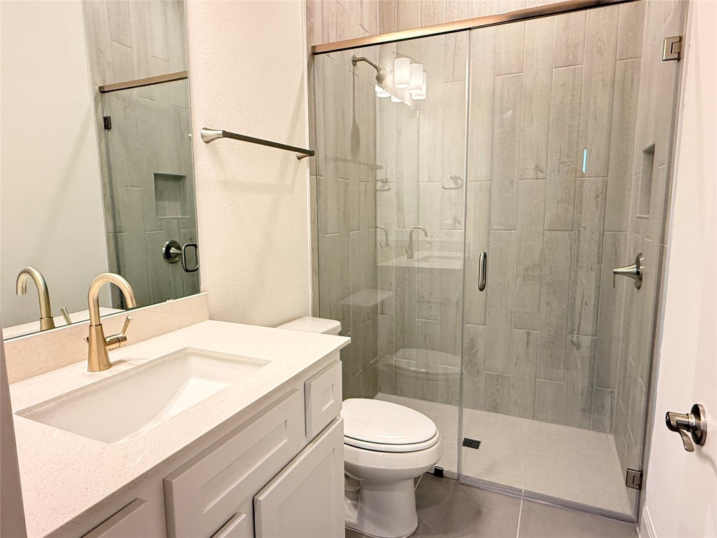 204 Rusty Colt Liberty Hill, TX 78642 - Photo 17 of 20 a bathroom with a sink a toilet and shower