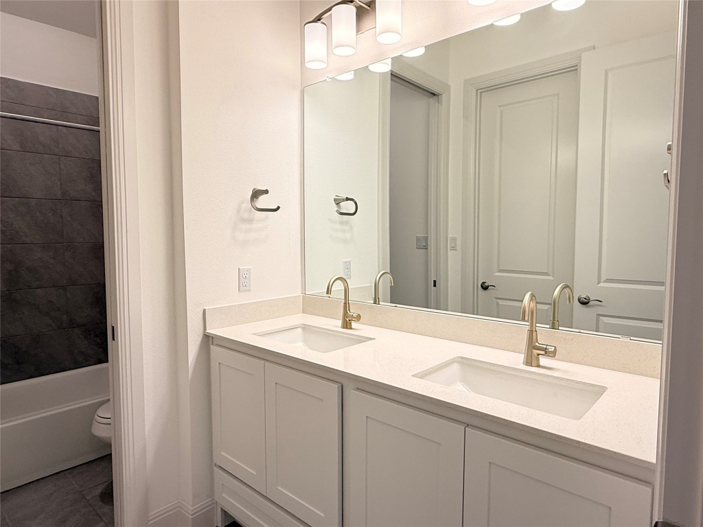 204 Rusty Colt Liberty Hill, TX 78642 - Photo 18 of 20 a bathroom with a sink and a mirror