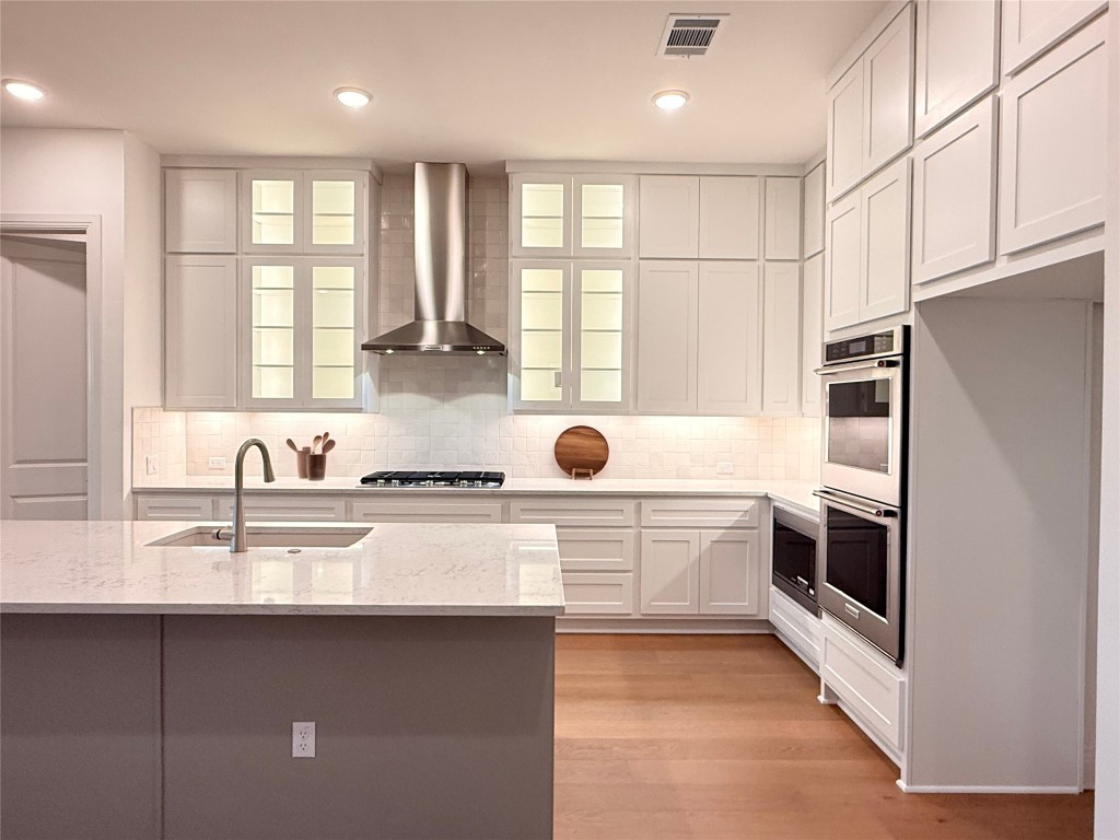 204 Rusty Colt Liberty Hill, TX 78642 - Photo 4 of 20 a kitchen with stainless steel appliances granite countertop a sink a stove and a refrigerator