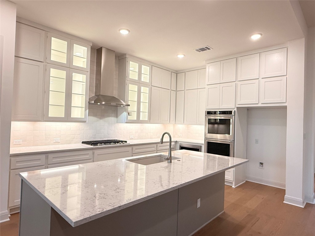 204 Rusty Colt Liberty Hill, TX 78642 - Photo 6 of 20 a kitchen with stainless steel appliances granite countertop a sink a stove and a refrigerator
