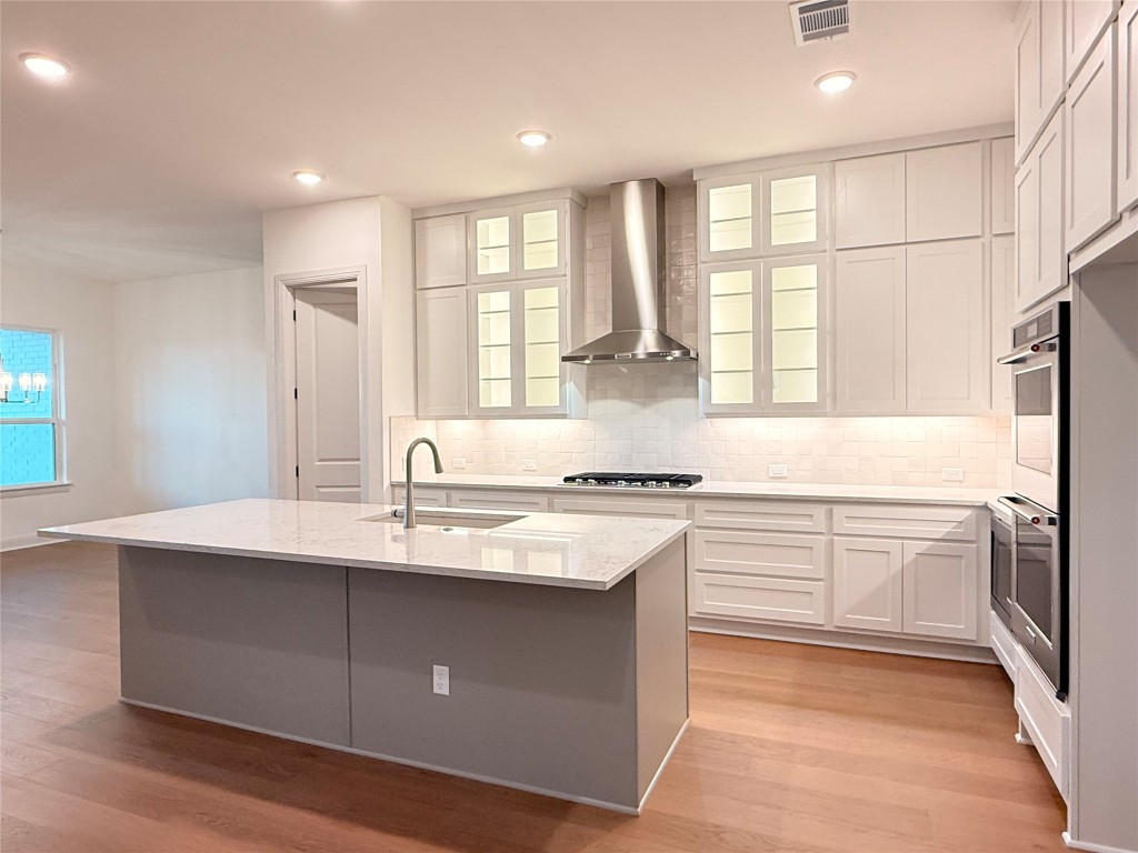 204 Rusty Colt Liberty Hill, TX 78642 - Photo 7 of 20 a kitchen with stainless steel appliances granite countertop a stove a sink and a refrigerator