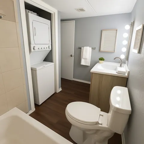 a white toilet sitting next to a bathroom sink and a mirror