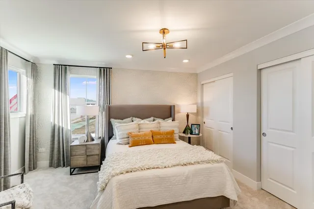 a bedroom with a bed and a chandelier