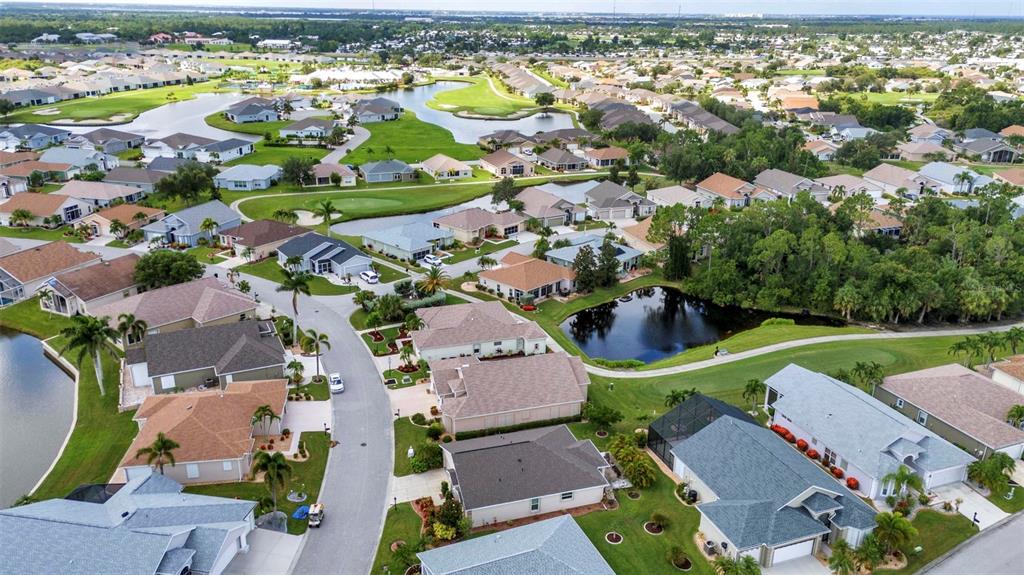 24419 Buckingham Way Punta Gorda, FL 33980 - Photo 19 of 40 an aerial view of a city with lots of residential buildings ocean and mountain view in back