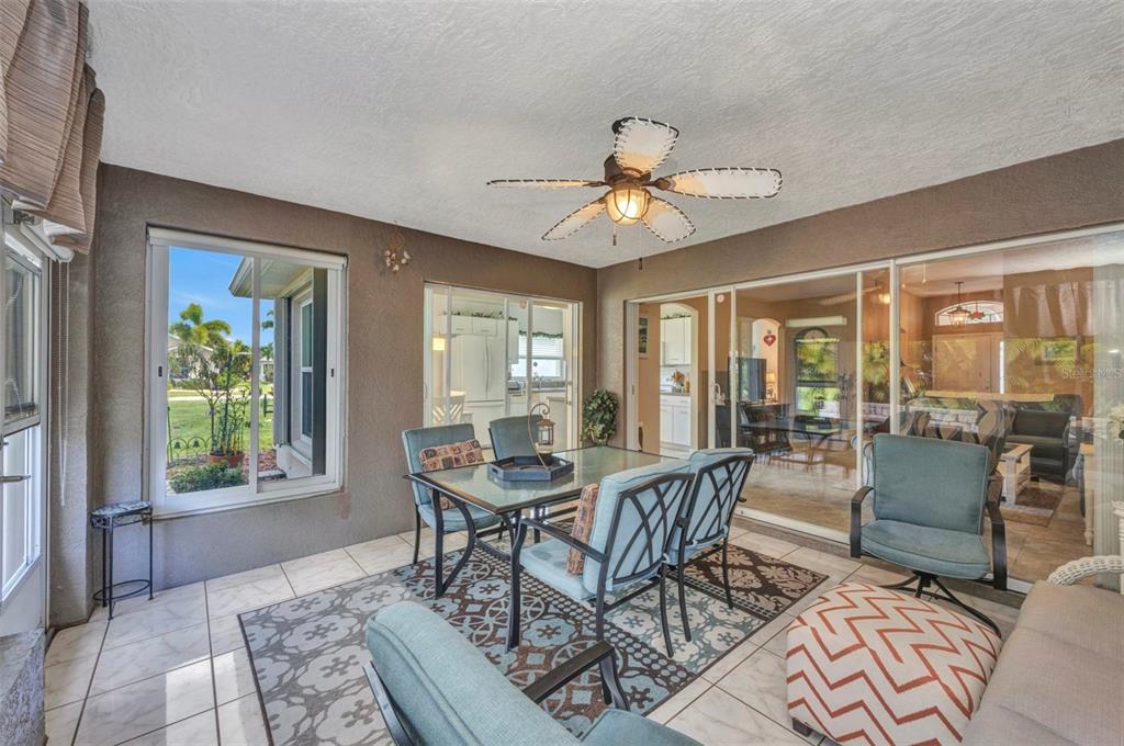 24419 Buckingham Way Punta Gorda, FL 33980 - Photo 8 of 40 a dining room with furniture a chandelier and wooden floor