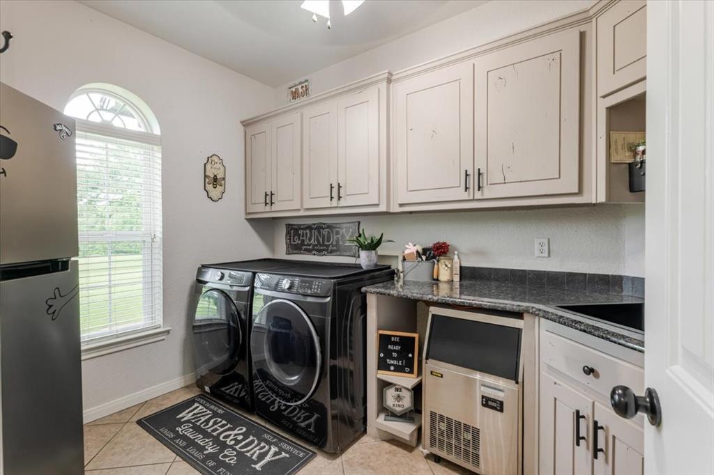 318 East Lone Star Road Poolville, TX 76487 - Photo 25 of 33 a kitchen with granite countertop a sink a stove and a window