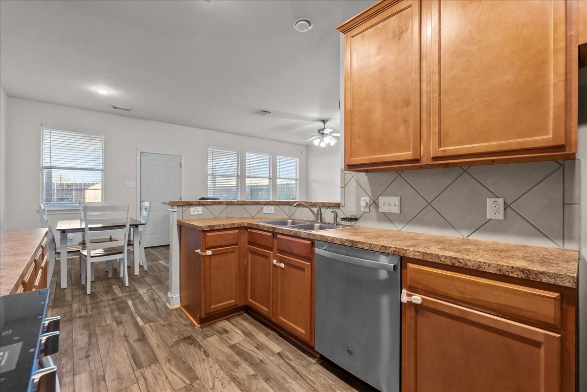 11931 Keystone Spring Way Houston, TX 77089 - Photo 11 of 34 a kitchen with stainless steel appliances granite countertop wooden cabinets a sink and a stove