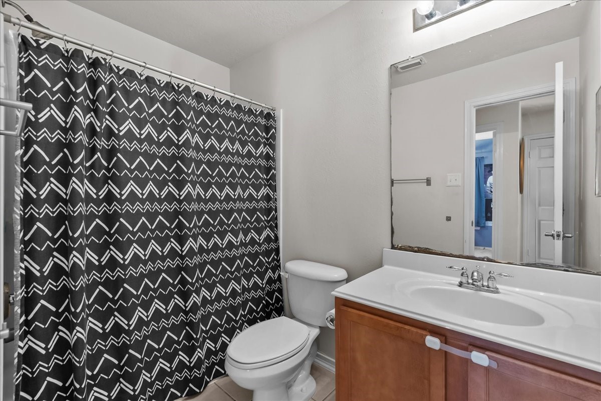 11931 Keystone Spring Way Houston, TX 77089 - Photo 20 of 34 a bathroom with a granite countertop toilet and a sink