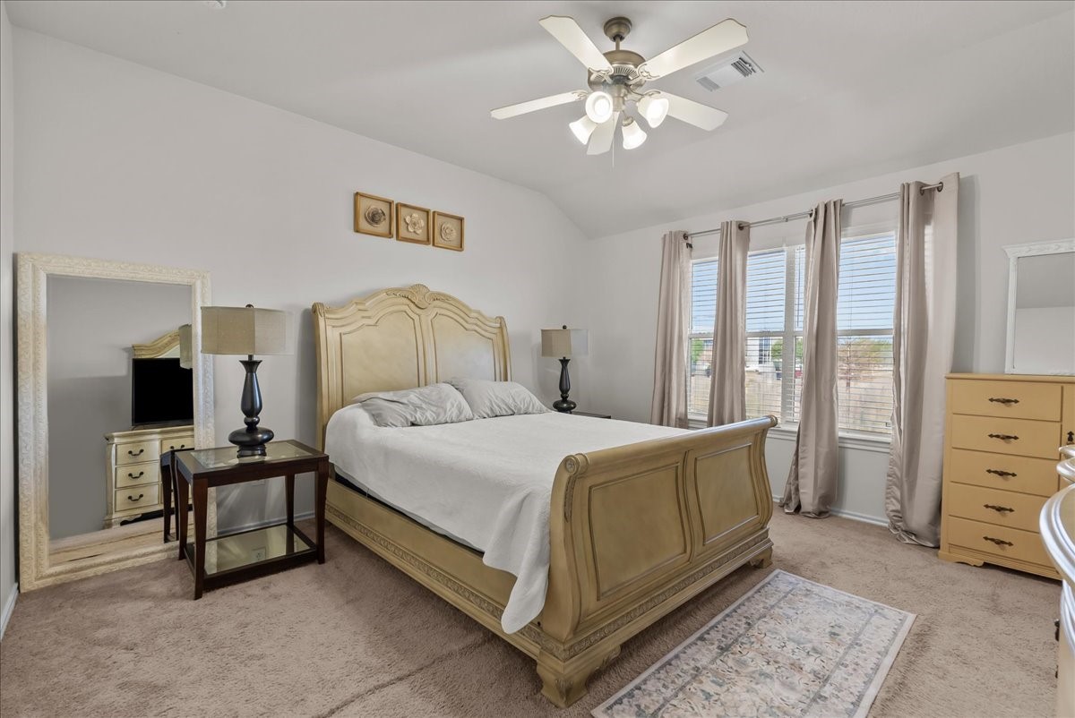 11931 Keystone Spring Way Houston, TX 77089 - Photo 23 of 34 a bedroom with a bed and a chandelier