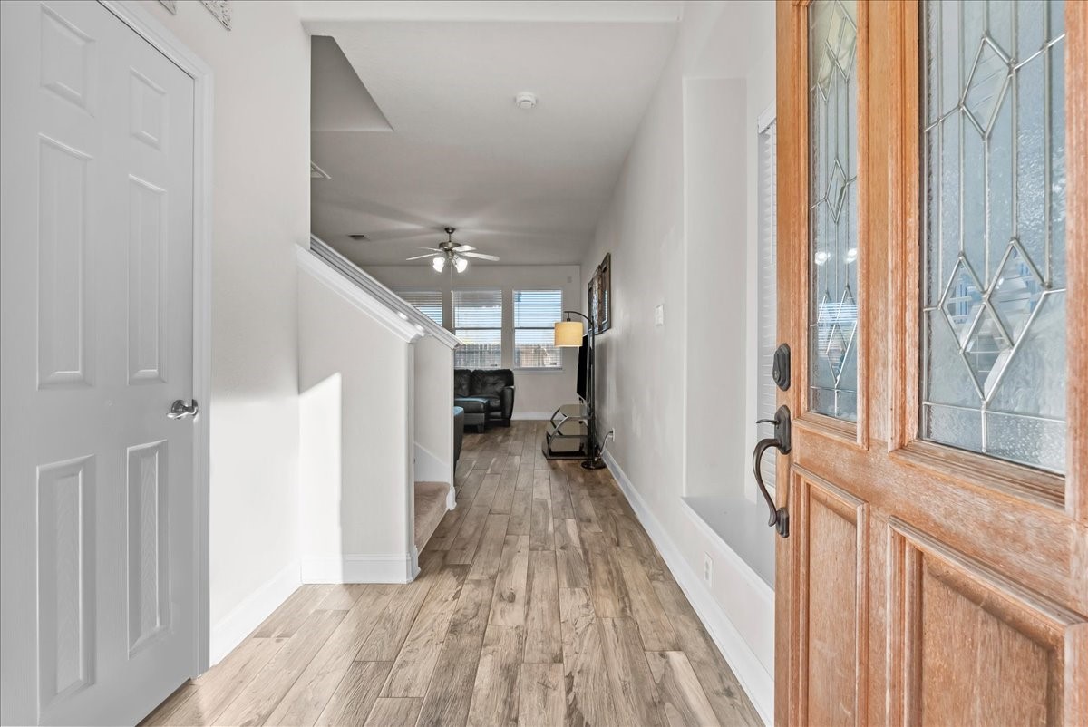 11931 Keystone Spring Way Houston, TX 77089 - Photo 4 of 34 a view of a hallway with wooden floor and staircase