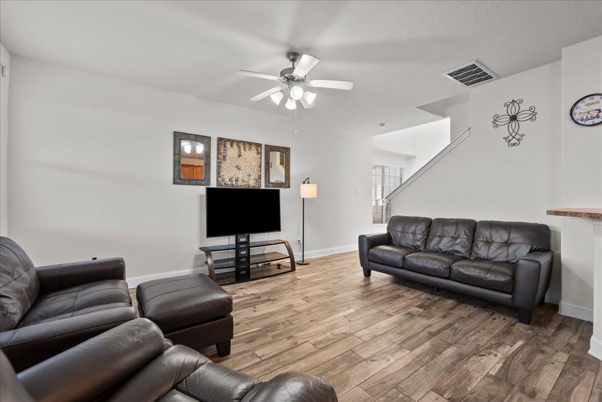 11931 Keystone Spring Way Houston, TX 77089 - Photo 5 of 34 a living room with furniture a ceiling fan and a window