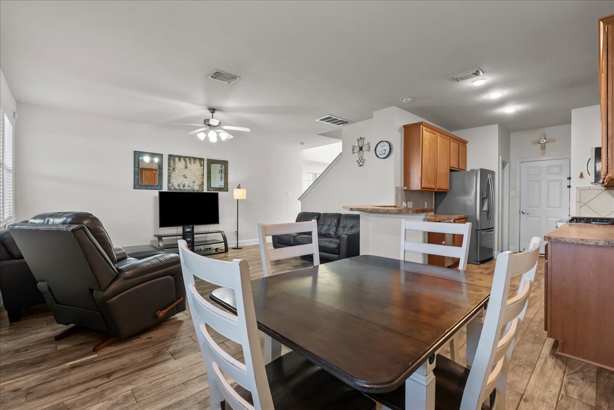 11931 Keystone Spring Way Houston, TX 77089 - Photo 9 of 34 a living room with furniture a flat screen tv and kitchen view