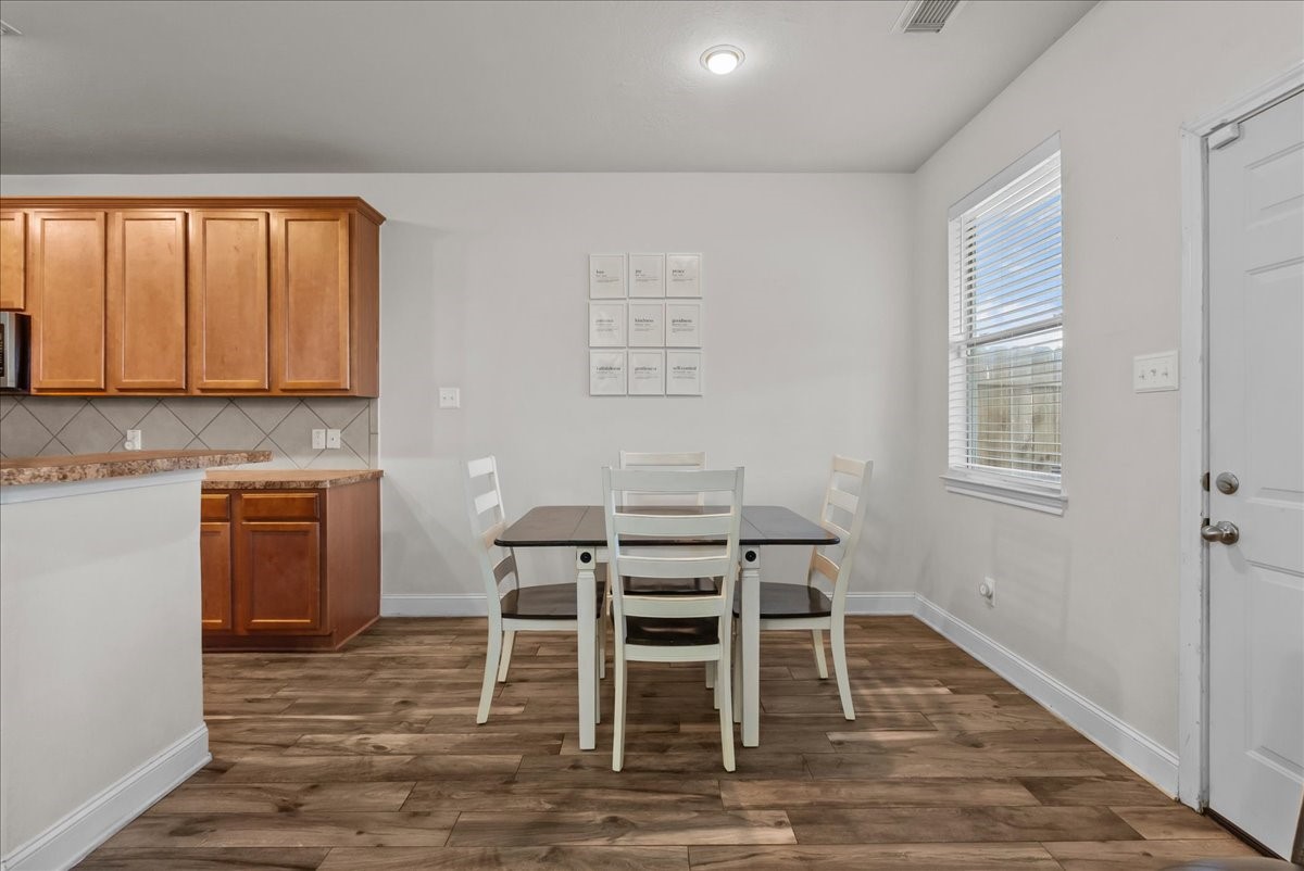11931 Keystone Spring Way Houston, TX 77089 - Photo 10 of 34 a dining room with a wooden table and chairs