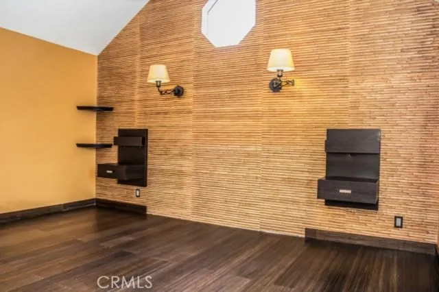 a bathroom with a wooden floor and a white wooden bench