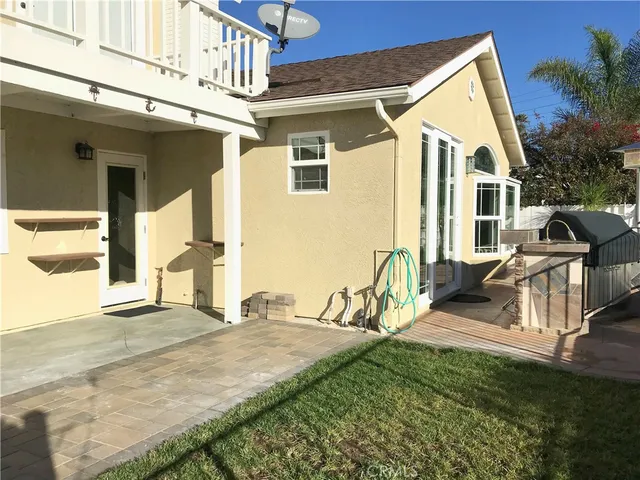 a view of a house with wooden fence