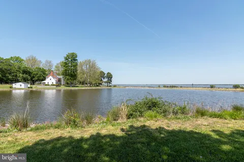 a view of a lake with houses in the back