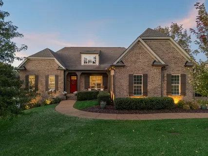 a front view of a house with a yard and porch