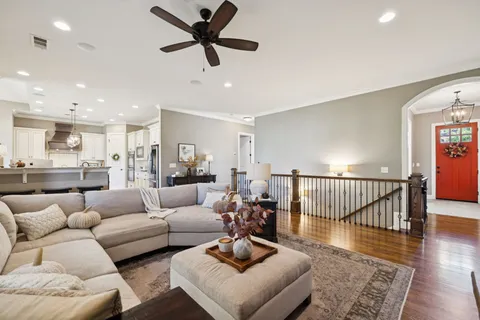 a large kitchen with granite countertop a stove a sink a dining table and chairs