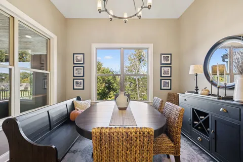 a bedroom with a bed gym equipment and a large window