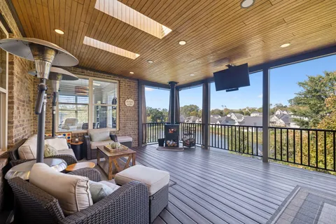 a living room with furniture a rug and a large window