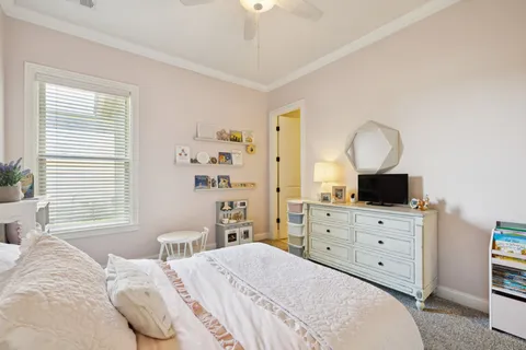 a bedroom with a bed and dresser with mirror