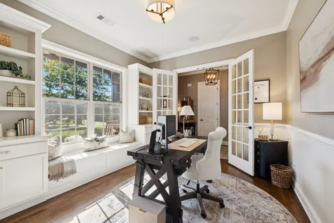 a living room with furniture and a view of kitchen
