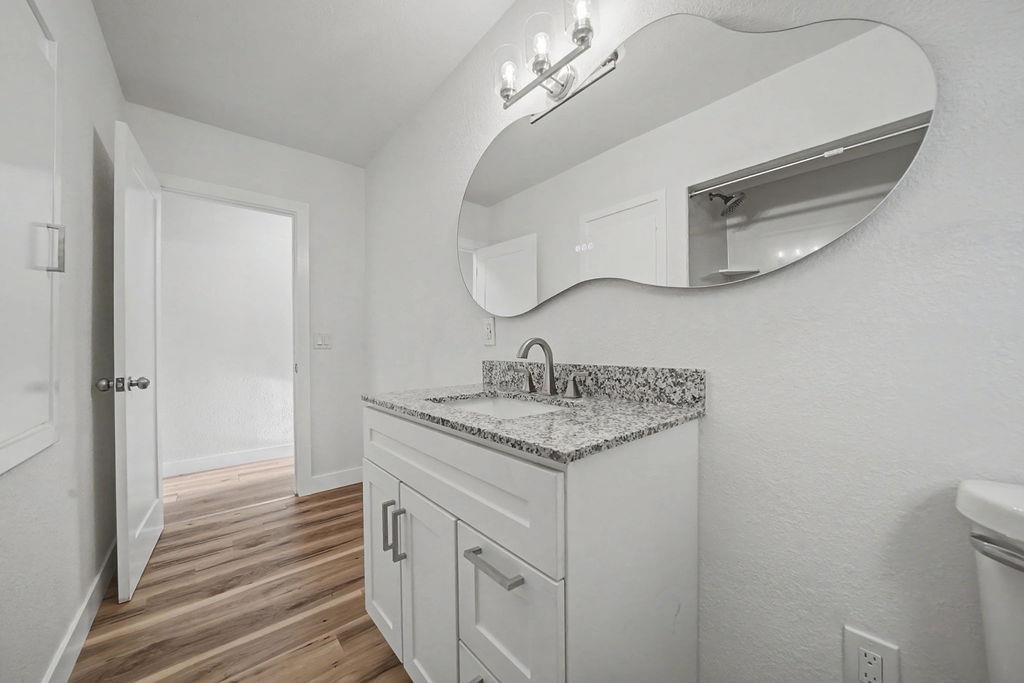155 Foothill Drive Sutter Creek, CA 95685 - Photo 11 of 84 a bathroom with a granite countertop sink a mirror and vanity