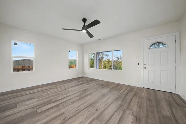 a view of a kitchen with a sink dishwasher a refrigerator and wooden floor