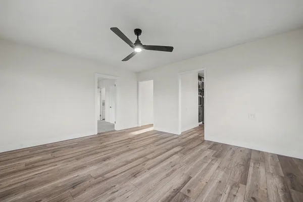 a kitchen with stainless steel appliances kitchen island granite countertop a sink and a stove top oven with wooden floor