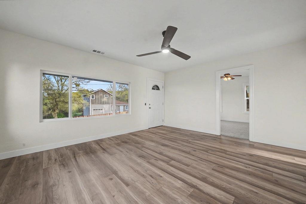155 Foothill Drive Sutter Creek, CA 95685 - Photo 16 of 84 a view of empty room with wooden floor and fan