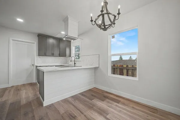 a kitchen with a refrigerator and a sink