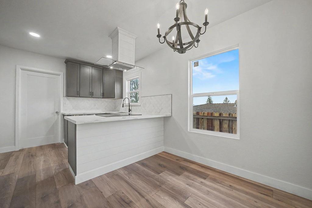 155 Foothill Drive Sutter Creek, CA 95685 - Photo 17 of 84 a view of a kitchen with a sink dishwasher a refrigerator and wooden floor