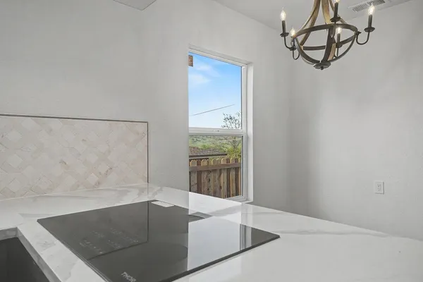 a kitchen with a sink dishwasher a stove and a microwave oven with wooden floor