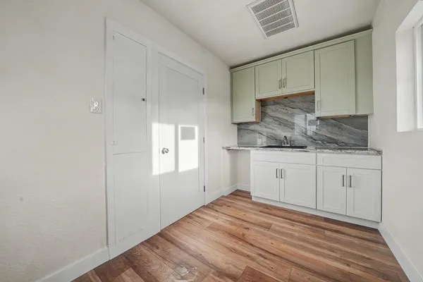 a front view of a house with wooden fence
