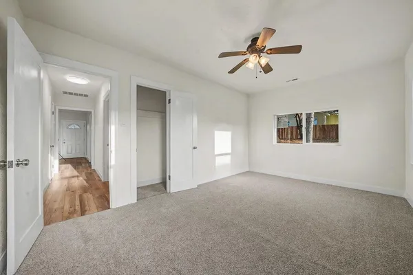 a view of a house with wooden fence