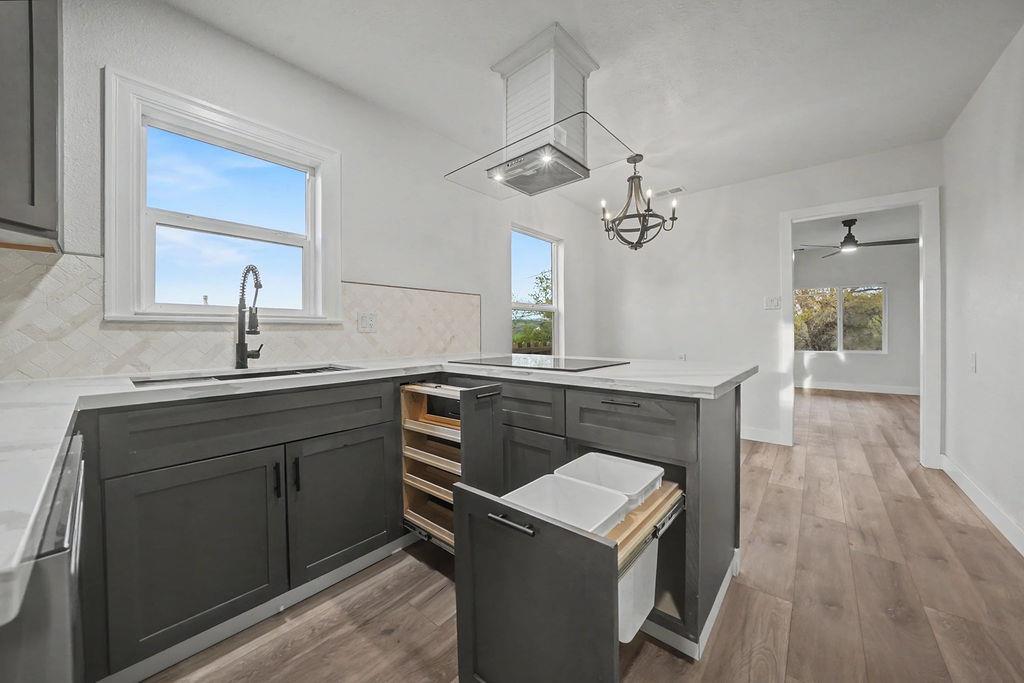 155 Foothill Drive Sutter Creek, CA 95685 - Photo 32 of 84 a kitchen with a sink dishwasher a stove and a microwave oven with wooden floor