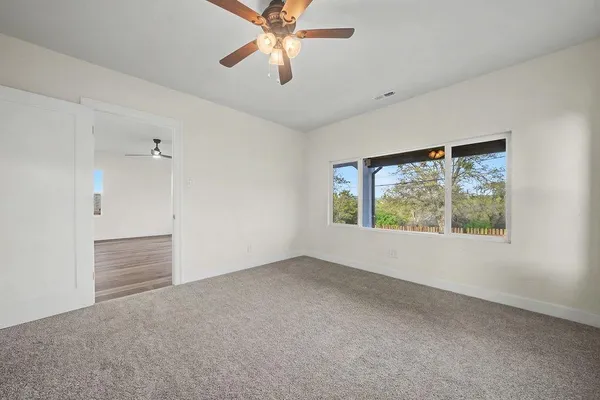 a bathroom with a granite countertop sink a mirror and vanity