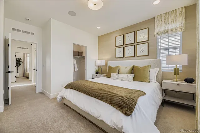 a spacious bedroom with a bed and a window