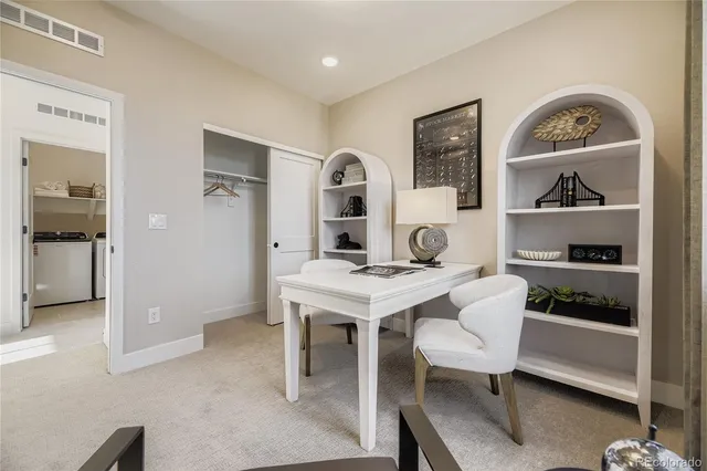 a view of a workspace with furniture and window