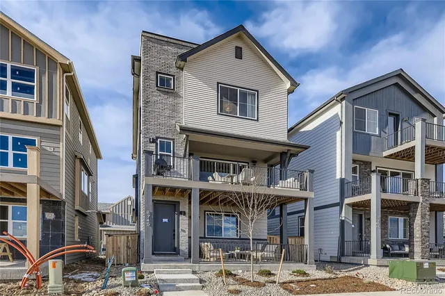 a front view of a residential apartment building with a yard