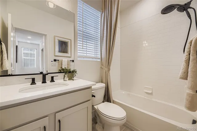 a bathroom with a sink toilet tub and shower