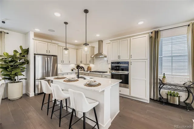 a kitchen with kitchen island a large counter top space appliances and cabinets