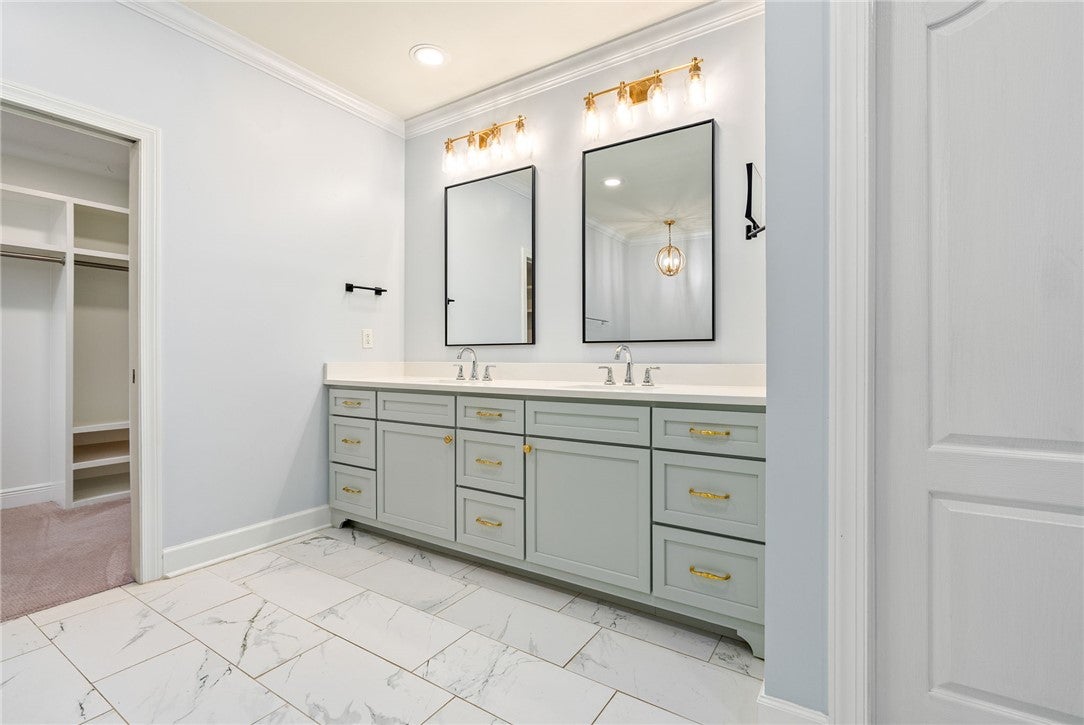 1657 Abby Road Auburn, AL 36830 - Photo 18 of 39 This spacious primary bathroom features a double vanity and an adjoining walk-in closet.